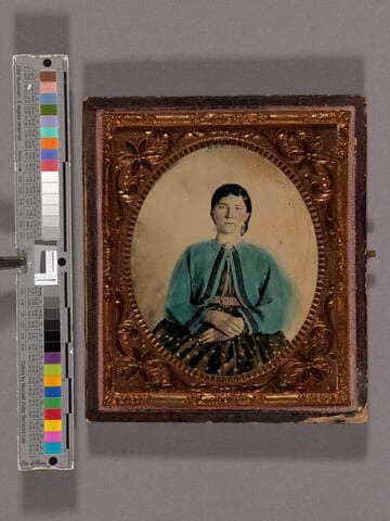 Portrait of unidentified woman wearing a coat hand-colored blue
