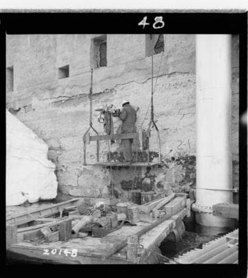 Showing upstream core drill hole 2-1, Dam 2, and drilling scaffold on hole 2-2