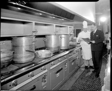 Matre D and Chef reviewing menu