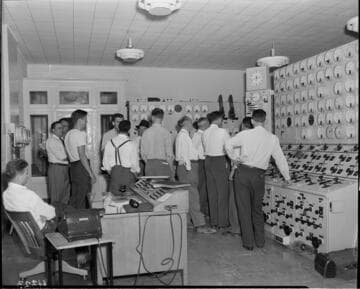 Big Creek tour group in a hydro power plant control room