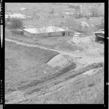 Man with a trophy and shots of construction at a home site