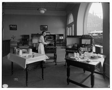 Miss Vera Ebert conducting a cooking demonstration with electric appliances at Edison Redlands Service Center
