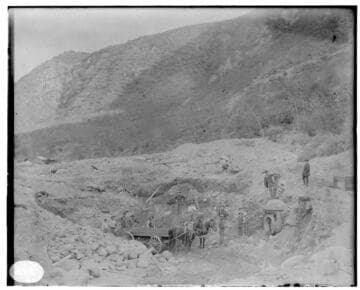 A construction crew and their horses at an unknown pipe and gate valve