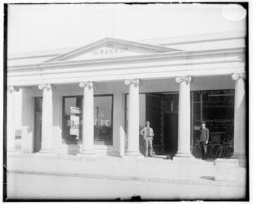 Two office workers standing in front of the Ocean Park Local Office