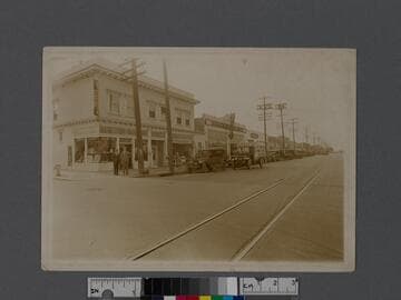 Los Angeles street corner with men in front of Arlington Pharmacy