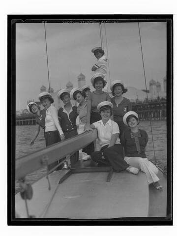 Young women on a boat at the Yacht Harbor Breakwater dedication, Santa Monica