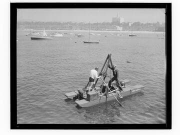 Men with anchor retrieval equipment in ocean off Santa Monica