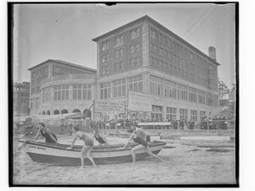 Swim team launching a lifeboat in front of Club Casa del Mar, Santa Monica, California