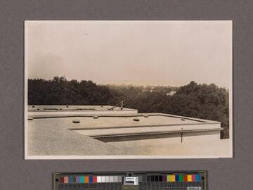 Huntington Library Construction: view showing the roofs of the East and West Wings, looking west