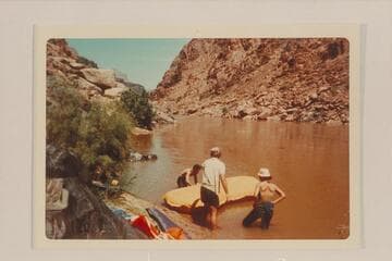 Bill Mooz inflates the small unit which was to convoy the air mattresses on Lake Mead to get them to Pierce Ferry.  Looking upriver about Mile 234 1/2