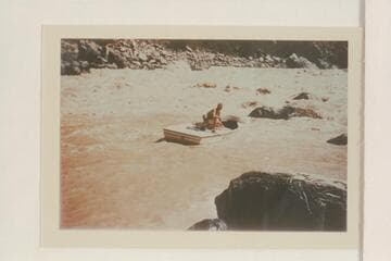 One of the Nevills sadirons slipping free from the rocks at the end of the lining at Vulcan Rapid.  Nevills perches on the deck