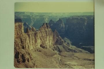 Lower end of Meriwitica looking down into Spencer Creek.  Meriwitica Spring at lower extreme right.  Meriwitica Cave shows plainly about middle of white wall just above the talus