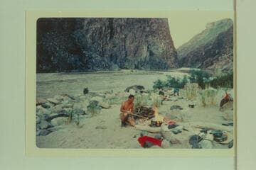 Camp at Travertine Creek with Travertine Rapid in background.  The island is submerged by high water