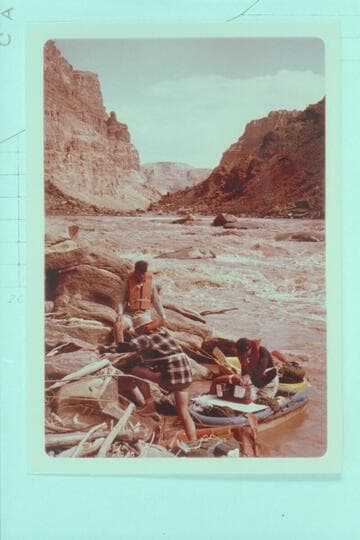 Upstream from foot of first drop of Rapid No. 23 which heads at Mile 202.20 and drops 9 ft. in 0.14 miles.  The Sliced Boulder is at right margin.  Buzz and Bill Belknap and Dock Marston work the Sportyaks.  Low water divides the rapid into 2 drops