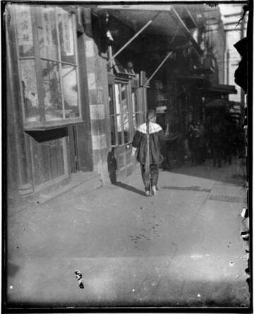 Person with long ponytail walking down street