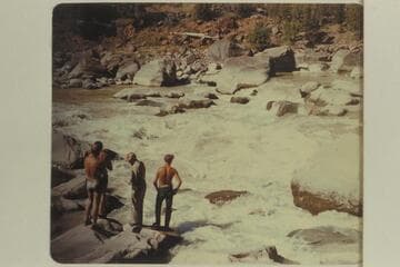 Bus Hatch's crew studying Hells Half Mile.  Bus wears the cap and shirt.  The others are Dale and Jack Collier, two boatmen, and Bill McLane, a passenger