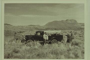Bill Belknap's Power Wagon on The Rim, south side above Lava Falls.  Jorgen Visbak stands next to the truck