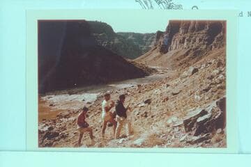 Photographing the Kolb inscription at the head of the talus at Mile 202.25.  Buzz Belknap; Jorgen Visbak; Dock Marston.  Rapid No. 23 in background at left