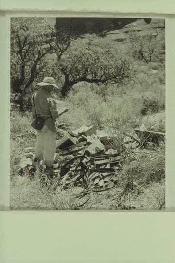 Marston examining the remnants of the still in Lava Creek Canyon about two miles from the river