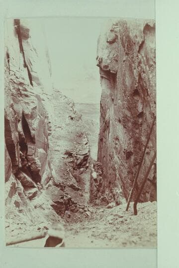 Appears to be Hole-in-the-Rock.  The development of the dredging enterprise of the Hoskaninni Company included some work at Hole-in-the-Rock.  Property included a cook stove and some pipe at this place in 1901.  From Stanton Collection of Photos