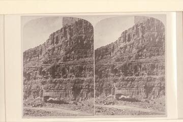 View of the Wall (See men and boats on bank of river).  The rapid is Dark Canyon Rapid