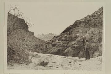 Kent Frost standing above first drop in Red Lake Canyon, also known as Butler Canyon.  He looks across to the Land of the Standing Rocks across the Colorado River.  Kent stands on ca. the 4560ft. contour as shown in the map Carlisle 3 NW Utah