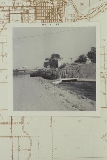 Looking east at timber flume pouring into concrete ditch