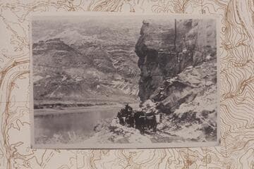 Ox team rounding the point on the dugway opposite the fort and at the point where the present gauge is located