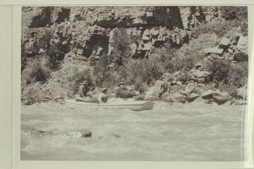 Loper at the oars in a small rapid in Red Canyon.  Trimble and Woolley are riding with him