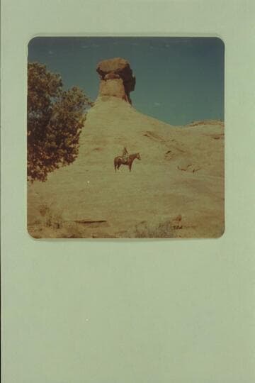 Tom Daly on the slick rock at foot of hammer heads.  Side canyon of Little Finger Canyon, Navajo Canyon
