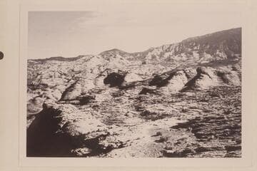 The basin of Nasja Creek from the point where the trail reaches the rim west of the mouth of the Creek.  Cha Butte is below Navajo Begay.  The basin of Bald Rock Creek is between Cha Butte and the sloping black top mesa at right.(Mesa 4903)
