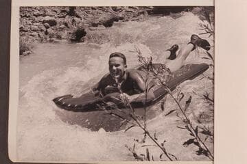 Bill Belknap gets some early training in running rapids.  Riding Havasu Creek on an air mattress
