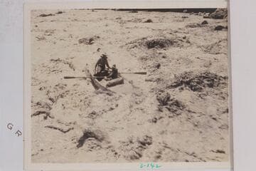 A skiff of the Dusty Dozen party in the lower end of Grapevine Rapid.  The boatman is running bow first and carrying a passenger