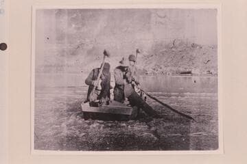 One boat of the Stanton-Ginty Glen Canyon trip of 1897-1898 with the men cutting ice to come in to the beach.  Eugene Ginty stands toward the bow.  The party started from Crescent Creek Oct. 13 and arrived at Lees Ferry in 1898, mid-Jan