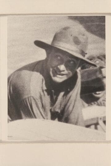 Clyde Eddy.  A rare photograph as it appears that he is smiling.  Eddy is assisting to bail the "Dellenbaugh" after its capsize below Sockdologer Rapid