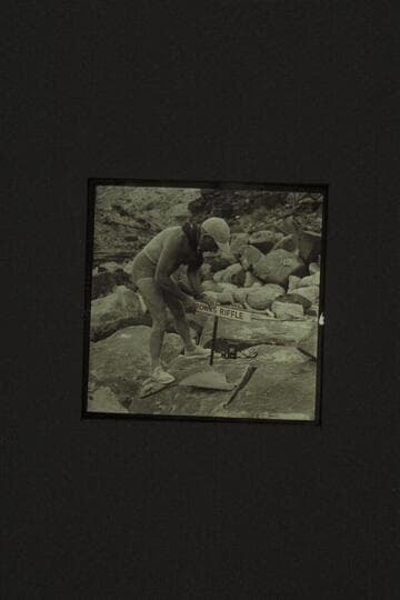 Marston pounding home the sign at Browns Riffle; Mile 12 in Marble Canyon where Frank Mason Brown was drowned 1889, July 10