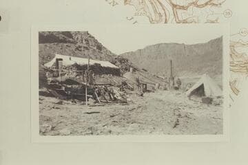 Camp Ibex showing rock-walled cook house and mess hall with canvas roof
