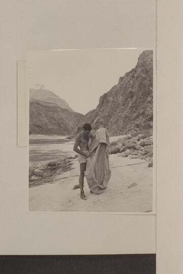 Garth Marston examines the rubber raft lost by the Scout Troop in Glen Canyon and found by the Nevills party at Mile 219; Diamond Creek