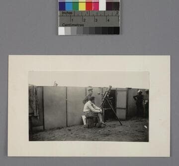 Edwin Powell Hubble, sitting by a telescope in Point Loma, California