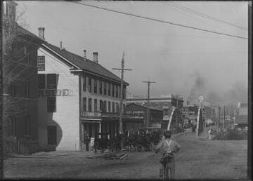 Street view of boy riding bicycle toward old Truckee Bridge, Reno, Nevada