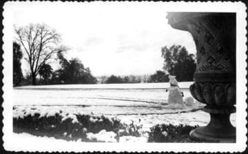 Snowman and east lawn after snowfall, February 1948