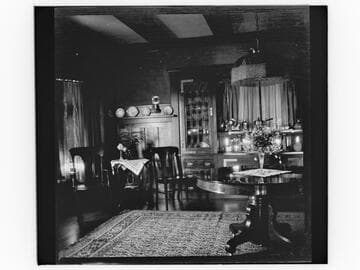 Unidentified house interior with flowers on table