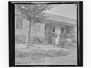 Unidentified house with child on porch