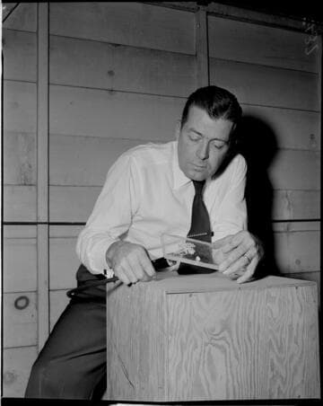 Man working with flowers embedded in clear plastic