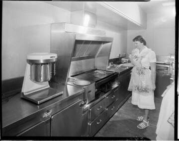Chef cooking on electric grill in commercial grade kitchen