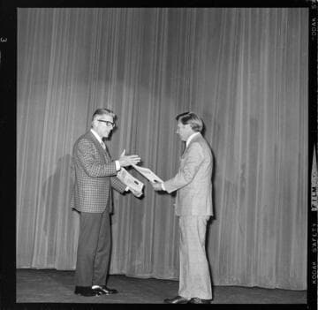 Architects & Engineers Forum presenting awards for "Efficiency In Utilization of Energy" to designers at a large banquet - displays set up at meeting showing improvements in electrical technology