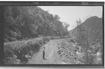 A man standing at Marble Fork at the Road #2 ditch excavation at Kaweah #3 Hydro Plant