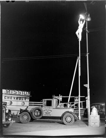 Mr. Patterson on ladder fixing San Gabriel floodlight