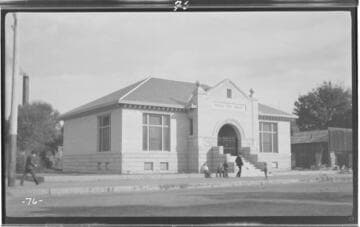A street scene focusing on the Visalia Carnegie "Free" Library