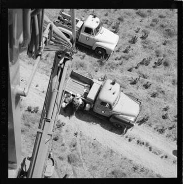 View from raised bucket of desert and truck below